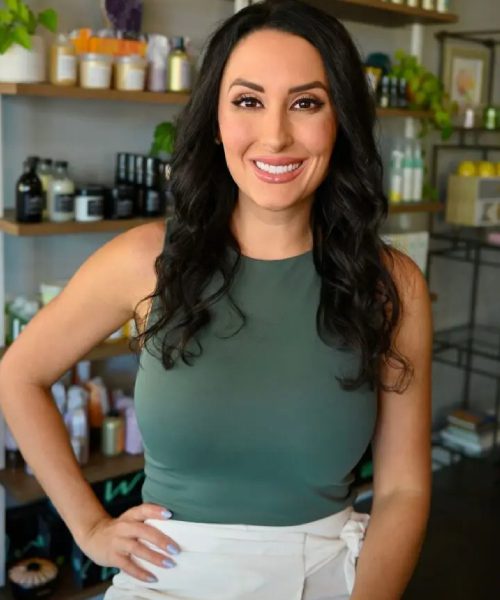 Smiling woman in a shop setting.